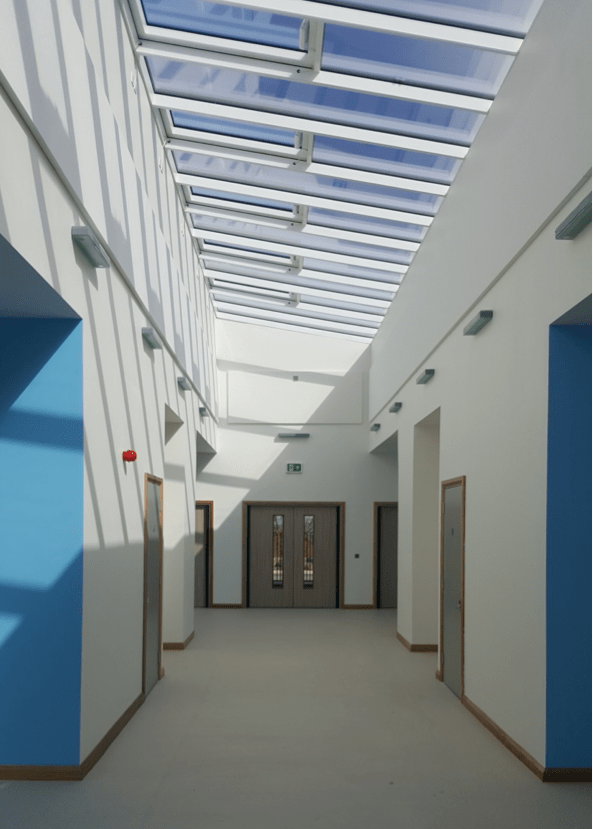 Wide bright corridor with glass ceiling